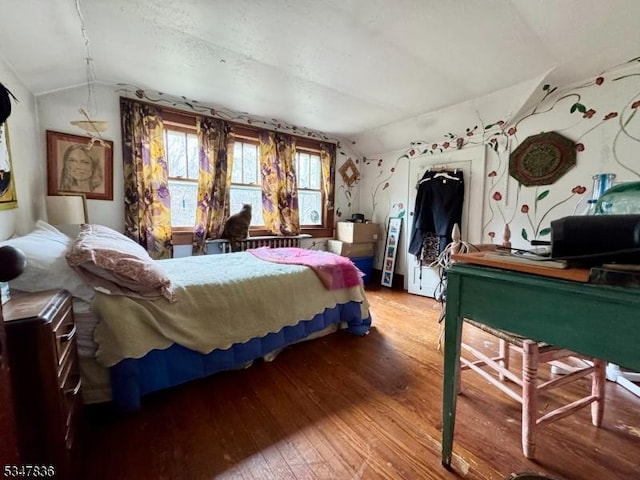 bedroom featuring hardwood / wood-style flooring and vaulted ceiling