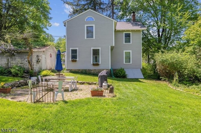 28 Academy St, Califon Boro, NJ 07830 - back of property featuring a chimney, a lawn, a patio area, and an outdoor structure