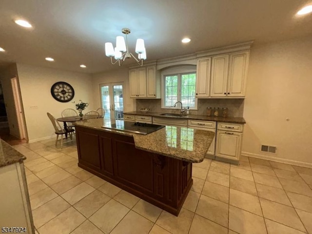 kitchen with a sink, visible vents, light tile patterned flooring, and black electric cooktop