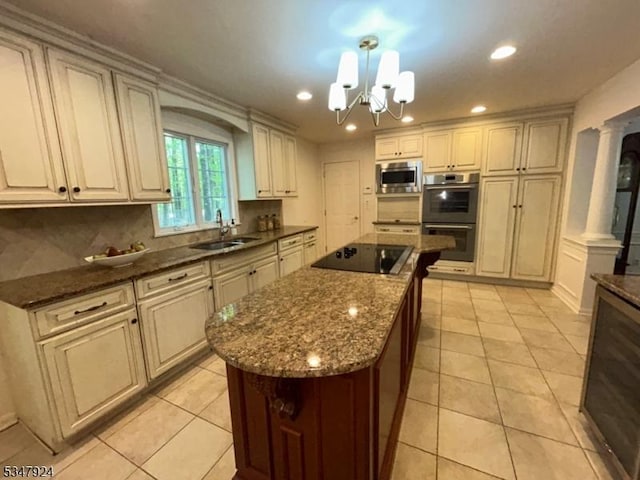 kitchen with a center island, black electric cooktop, a sink, multiple ovens, and stainless steel microwave