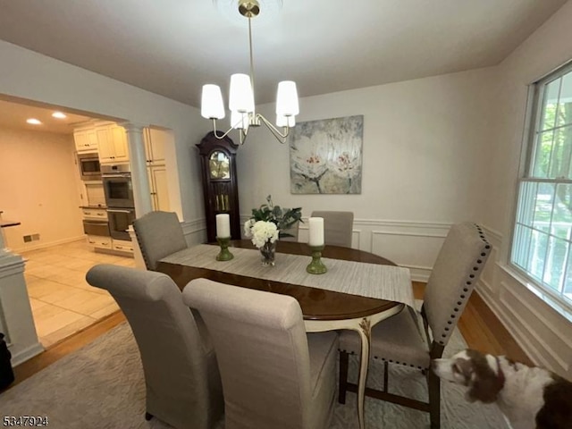 dining space featuring recessed lighting, a notable chandelier, and light wood-type flooring