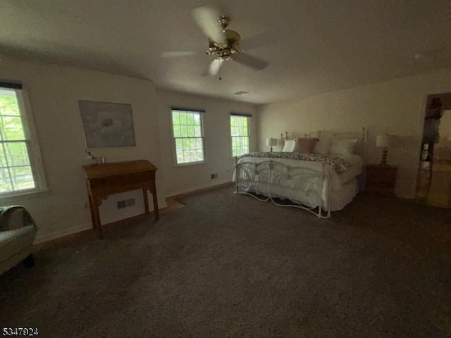 carpeted bedroom featuring baseboards, visible vents, and ceiling fan