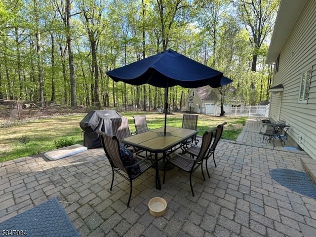 view of patio / terrace featuring outdoor dining space, a fenced backyard, and a grill