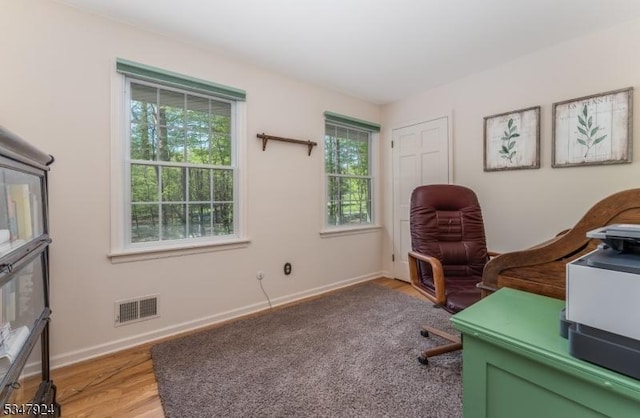 home office featuring baseboards, a wealth of natural light, light wood-style flooring, and visible vents