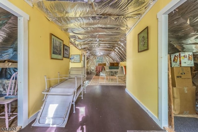 hallway featuring vaulted ceiling
