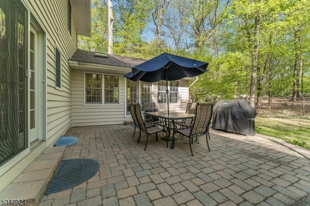 view of patio with outdoor dining space and a grill