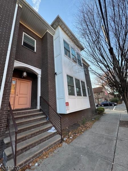 view of front of property with brick siding and entry steps