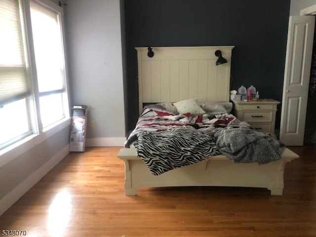 bedroom featuring baseboards and light wood-style floors