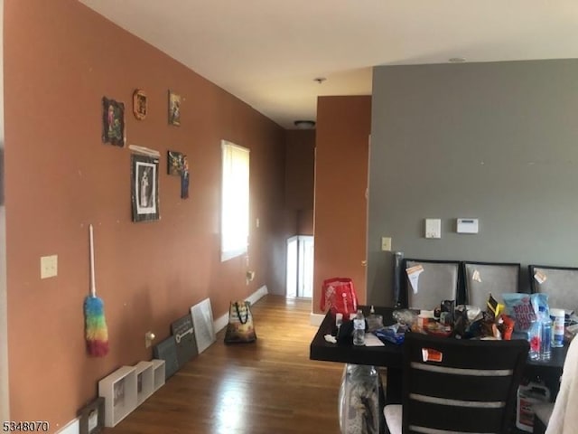interior space featuring baseboards and wood finished floors