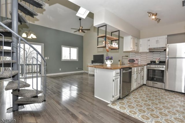 3 Davos Dr Unit 6, Vernon Twp, NJ 07462 - kitchen featuring baseboards, open floor plan, butcher block counters, under cabinet range hood, and stainless steel appliances