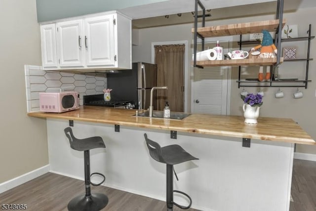 3 Davos Dr Unit 6, Vernon Twp, NJ 07462 - kitchen featuring wood counters, white microwave, dark wood-style flooring, and a sink