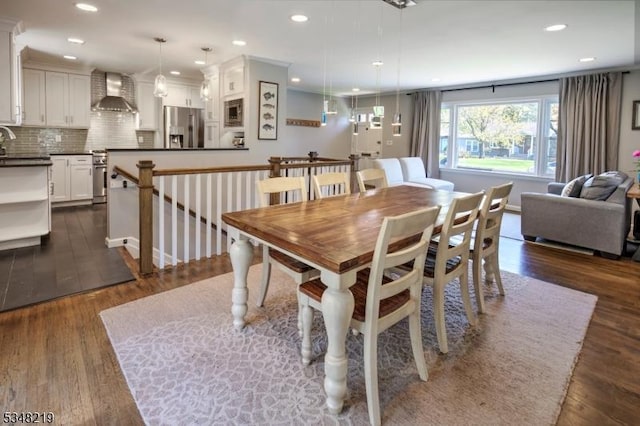 dining space with recessed lighting and dark wood-type flooring
