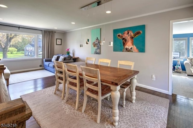 dining space with wood finished floors, crown molding, recessed lighting, and baseboards