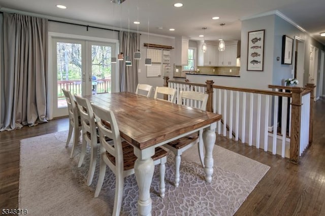 dining area with wood finished floors, french doors, recessed lighting, and crown molding