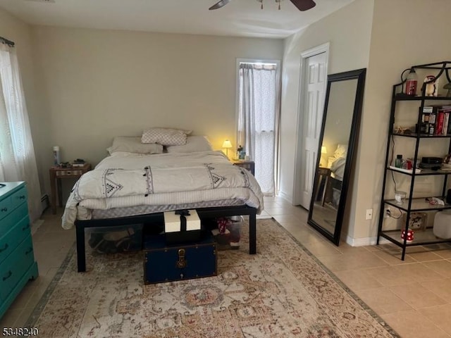 bedroom with a ceiling fan and light tile patterned floors