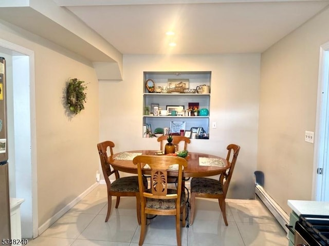 dining space featuring baseboards and light tile patterned flooring