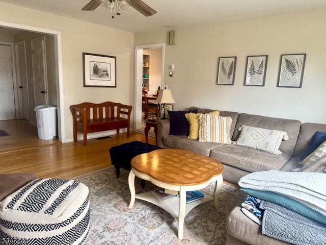 living room with a ceiling fan and wood finished floors