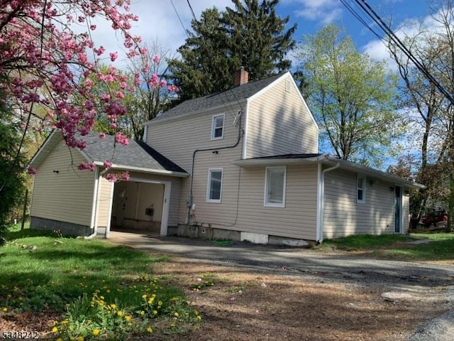 826 Green Pond Rd, Rockaway Twp, NJ 07866 - rear view of house with an attached garage, asphalt driveway, and a chimney