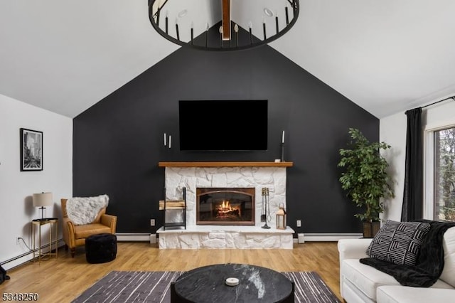 16 James Rd, Randolph Twp, NJ 07869 - living area featuring lofted ceiling, a baseboard radiator, wood finished floors, and a fireplace