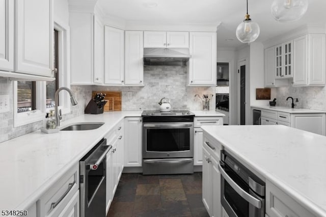 16 James Rd, Randolph Twp, NJ 07869 - kitchen with appliances with stainless steel finishes, under cabinet range hood, white cabinets, tasteful backsplash, and pendant lighting