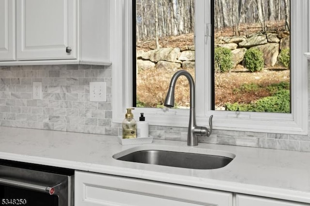 16 James Rd, Randolph Twp, NJ 07869 - kitchen featuring white cabinetry, backsplash, light stone countertops, and dishwasher