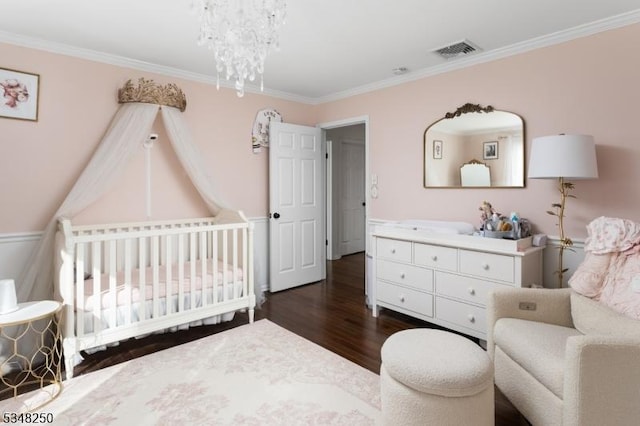 16 James Rd, Randolph Twp, NJ 07869 - bedroom with dark wood-style flooring, ornamental molding, a crib, and a chandelier