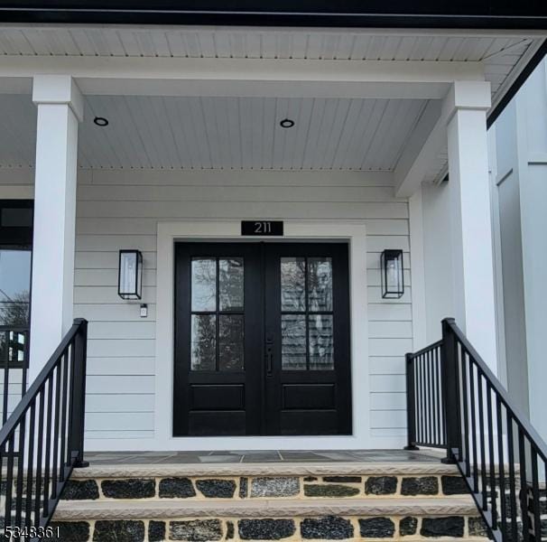 view of exterior entry with french doors and covered porch
