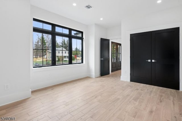 unfurnished bedroom with recessed lighting, visible vents, and light wood-style floors