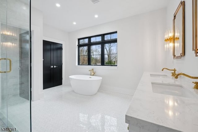 bathroom featuring a soaking tub, tile patterned flooring, a sink, and a shower stall