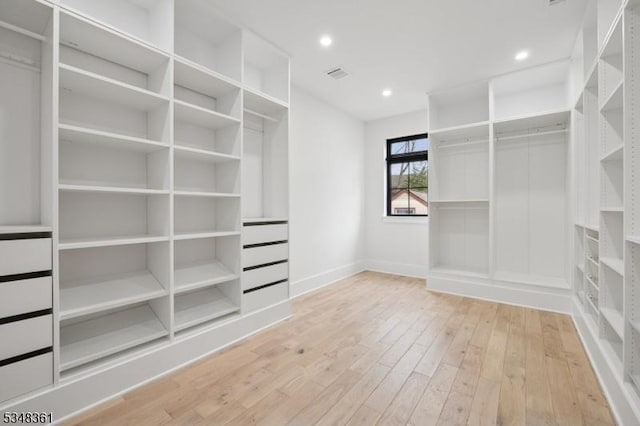 spacious closet with hardwood / wood-style flooring and visible vents