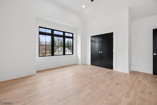 unfurnished bedroom featuring vaulted ceiling, wood finished floors, baseboards, ceiling fan, and recessed lighting