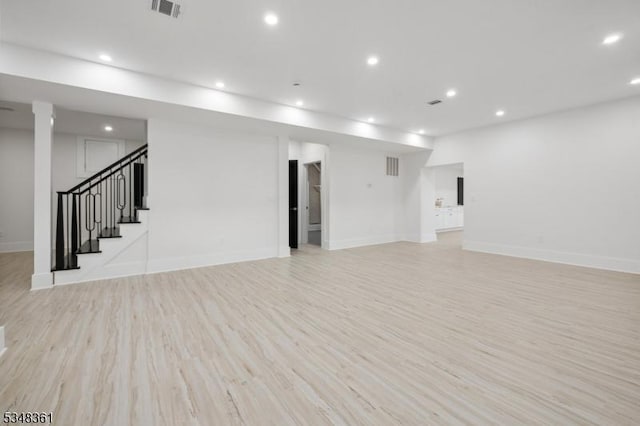 basement with stairs, light wood-style flooring, baseboards, visible vents, and recessed lighting