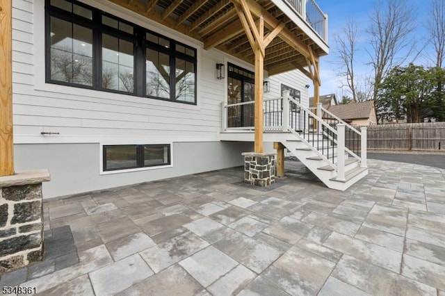 view of patio / terrace with stairs and fence