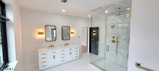 full bathroom featuring recessed lighting, a shower stall, a sink, visible vents, and double vanity