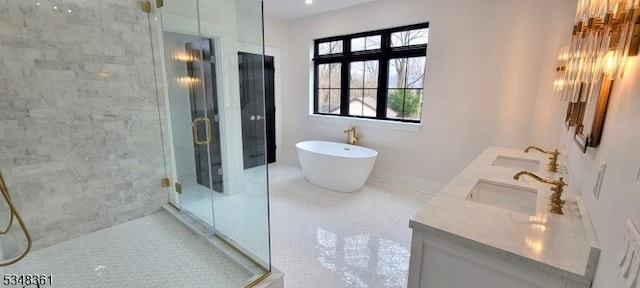 full bath with double vanity, a sink, and a stall shower
