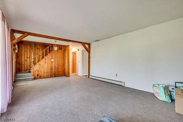 unfurnished living room with a baseboard heating unit, carpet flooring, and stairs