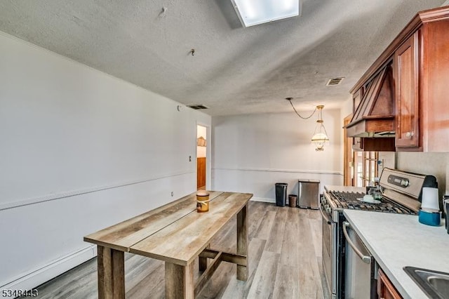 kitchen with visible vents, light wood finished floors, and stainless steel appliances