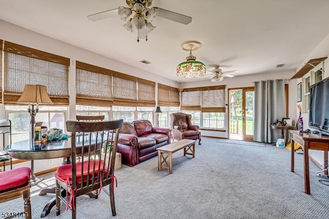 carpeted living area with a ceiling fan and visible vents