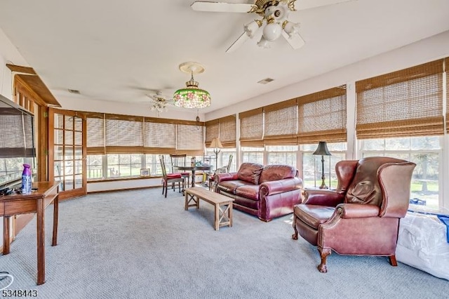 carpeted living room featuring visible vents, a wealth of natural light, and ceiling fan