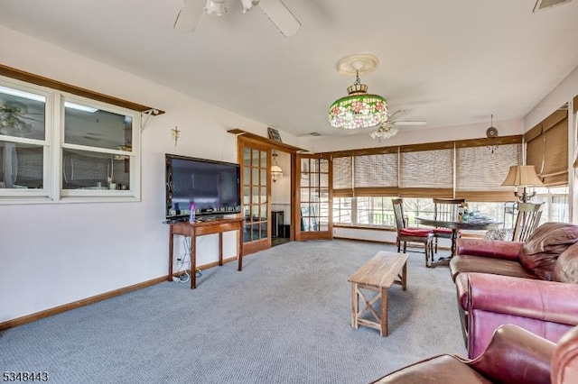 living area with carpet floors, a healthy amount of sunlight, and ceiling fan
