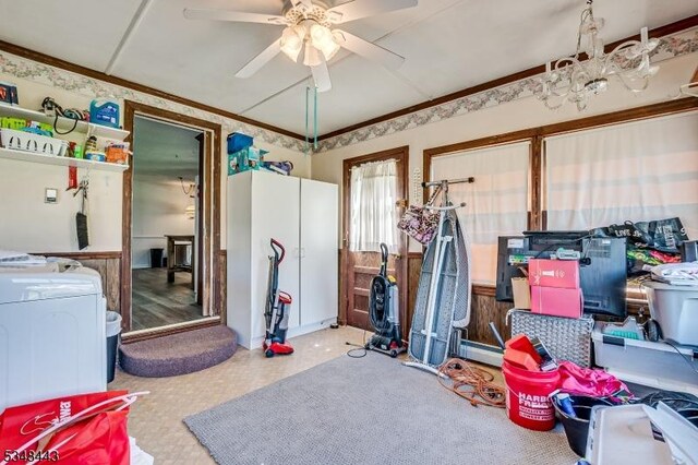 storage area featuring ceiling fan, baseboard heating, and washer / clothes dryer
