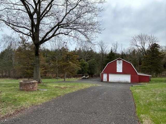 garage featuring aphalt driveway and a detached garage