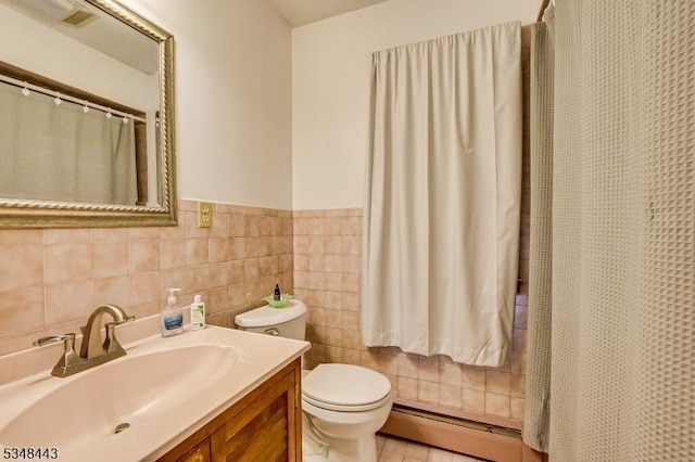 bathroom featuring toilet, wainscoting, visible vents, vanity, and a baseboard radiator