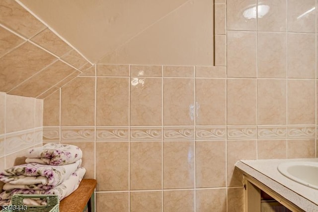 bathroom featuring tile walls and vanity