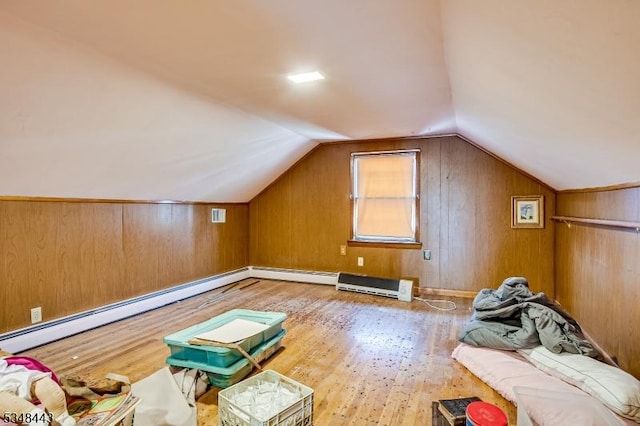 bonus room featuring wood finished floors, lofted ceiling, baseboard heating, and wood walls