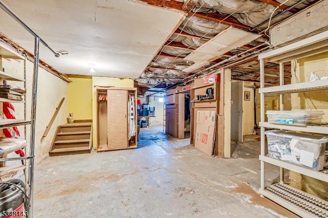 unfinished basement featuring stairs