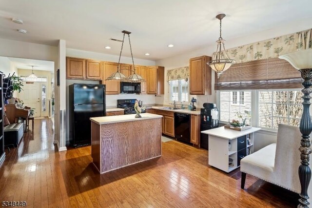 4 Hardenbergh St, Franklin Twp, NJ 08873 - kitchen featuring decorative light fixtures, light countertops, black appliances, and hardwood / wood-style flooring