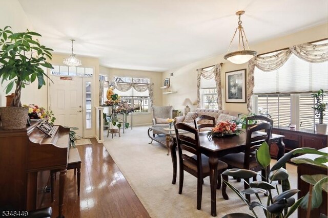 4 Hardenbergh St, Franklin Twp, NJ 08873 - dining space featuring hardwood / wood-style flooring and an inviting chandelier