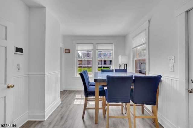 dining room featuring wainscoting and wood finished floors