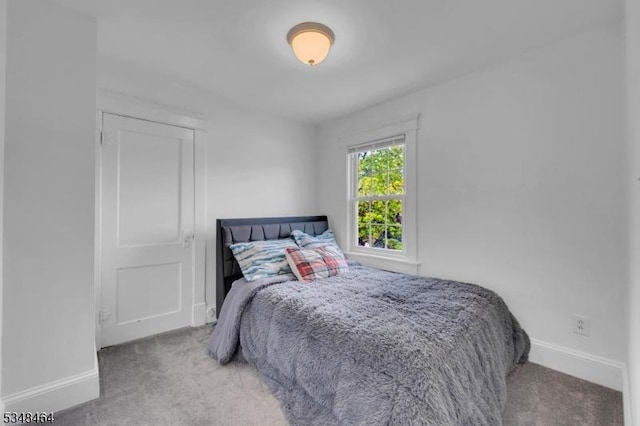 carpeted bedroom featuring baseboards